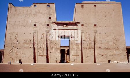 Tempel von Edfu, einer der am besten erhaltenen Schreine gewidmet vor allem Horus im oberen Nil, Ägypten. Der Haupteingang des Edfu-Tempels zeigt den ersten Mast. Archivscan von einem Dia. Februar 1987. Stockfoto