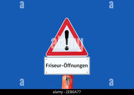 Achtung Warnschild Friseur Öffnungen auf blauem Hintergrund in deutsch Stockfoto