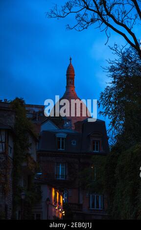 PARIS, FRANKREICH - 16. NOVEMBER 2019: Abendansicht Montmartre Viertel mit 'La Maison Rose' (Pink House) Restaurant und Kuppel der Basilika Sa Stockfoto