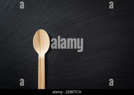 Biologisch abbaubares Einweggeschirr aus Holzlöffel, auf Marmorstruktur. Nahaufnahme. Stockfoto