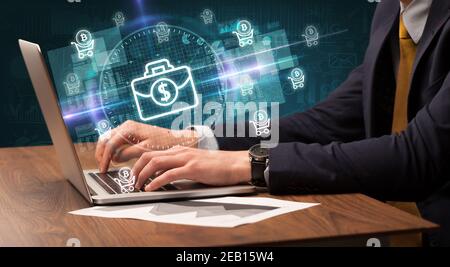 Business Hand arbeiten an der Börse mit Aktenkoffer Symbole kommen Aus dem Laptop-Bildschirm Stockfoto