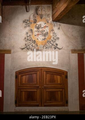 TRIENT, ITALIEN - 1. JUNI 2019: Bemaltes Wappen und hölzerne Fensterläden im Schloss buonconsiglio Stockfoto