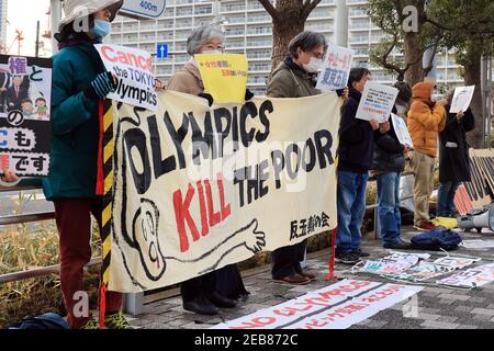 Tokio, Japan. Februar 2021, 12th. Anti-Olympia-Aktivisten halten Plakate und ein Banner bei einer Kundgebung gegen die Olympischen Spiele in Tokio vor dem Sitz des Organisationskomitees der Olympischen Spiele in Tokio am Freitag, den 12. Februar 2021. Yoshiro Mori, Präsident des Organisationskomitees der Olympischen Spiele in Tokio, trat wegen seiner sexistischen Äußerungen zurück. Quelle: Yoshio Tsunoda/AFLO/Alamy Live News Stockfoto