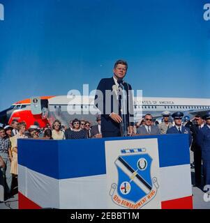 Reise in die westlichen Staaten: Castle Air Force Base, Kalifornien, 4:55pm Uhr. Präsident John F. Kennedy (bei Mikrofonen) gibt nach seiner Ankunft auf der Castle Air Force Base in Merced County, Kalifornien, eine Rede ab. Ebenfalls abgebildet: Gouverneur von Kalifornien, Edmund G. u201cPatu201d Brown; Geheimagent des Weißen Hauses, John Campion. Air Force One sitzt im Hintergrund. Stockfoto