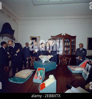 Treffen mit Haile Selassie I., Kaiser von Äthiopien, 4:00pm. Präsident John F. Kennedy betrachtet eine filigrane Schale während eines Geschenkwechsels mit Kaiser von Äthiopien, Haile Selassie I, im Fischzimmer des Weißen Hauses. Von links nach rechts: Nicht identifiziert; US-Botschafter in Äthiopien, Edward M. Korry; nicht identifiziert (hinten); Minister des Kaiserlichen Hofes von Äthiopien, Tafarra-Worq Kidane-Wold; Kaiser Selassie; nicht identifiziert; Präsident Kennedy; Imru Haile Selassie, zweiter Cousin von Kaiser Selassie. Washington, D.C. Stockfoto