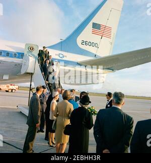 Reise nach Texas: Houston: Ankunft am Houston International Airport. Präsident John F. Kennedy (unten in der Mitte, teilweise versteckt) und First Lady Jacqueline Kennedy (mit einem Strauß gelber Rosen) begrüßen Vizepräsident Lyndon B. Johnson, Lady Bird Johnson und andere Mitglieder des Flughafenempfangsausschusses bei ihrer Ankunft an Bord der Air Force One am Houston International Airport in Houston, Texas. Zu Fuß nach unten Flugzeugtreppen sind (von oben): Vertreter Jack Brooks (Texas); Military Aide to the President, General Chester V. Clifton; Senator Ralph W. Yarborough (Texas); Vertreter Albert T. Stockfoto