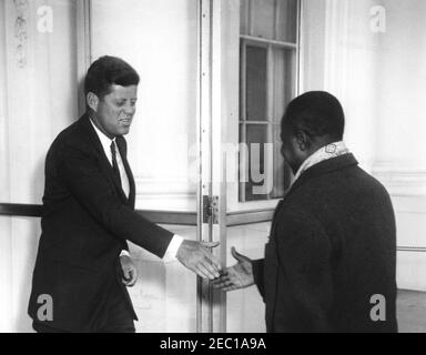 Mittagessen zu Ehren von Ahmadou Ahidjo, Präsident von Kamerun, 1:00pm Uhr. Präsident John F. Kennedy schüttelt die Hände mit Präsident von Kamerun, Ahmadou Ahidjo, bei der Ankunft von Präsident Ahidjou2019s im Weißen Haus für ein Mittagessen zu seinen Ehren. North Portico, White House, Washington, D.C. Stockfoto