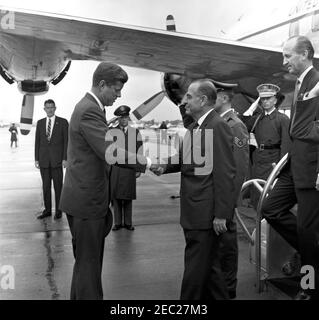 Ankunft von Roberto F. Chiari, Präsident von Panama, 11:00am Uhr. Präsident John F. Kennedy schüttelt die Hände mit Präsident von Panama, Roberto F. Chiari (Mitte), bei der Ankunftszeremonie zu Ehren von Präsident Chiari. US-Chef des Protokolls, Angier Biddle Duke, steht auf der Treppe auf der rechten Seite, und Security Officer für das State Department, James M. McDermott, steht im Hintergrund (links von Präsident Kennedy). Alle anderen sind nicht identifiziert. Military Air Transport Service (MATS) Terminal, Washington National Airport, Washington, D.C. Stockfoto