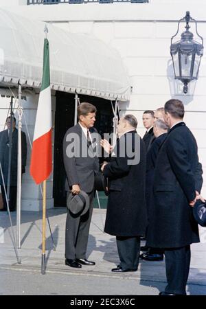 Eintreffen des italienischen Ministerpräsidenten Amintore Fanfani,11:15am Uhr. Präsident John F. Kennedy (mit Hut) spricht mit dem Botschafter Nicaraguas und dem Dekan des Diplomatischen Korps, Dr. Guillermo Sevilla-Sacasa, bei den Ankunftszeremonien für Premierminister Amintore Fanfani von Italien. Der Direktor für Westeuropäische Angelegenheiten im Außenministerium, Francis E. Meloy, steht im Hintergrund (rechts von Sevilla-Sacasa); der stellvertretende Chef des Protokolls für Besuche und öffentliche Veranstaltungen, Samuel L. King (zurück zur Kamera), steht ganz rechts. South Portico, White House, Washington, D.C. Stockfoto