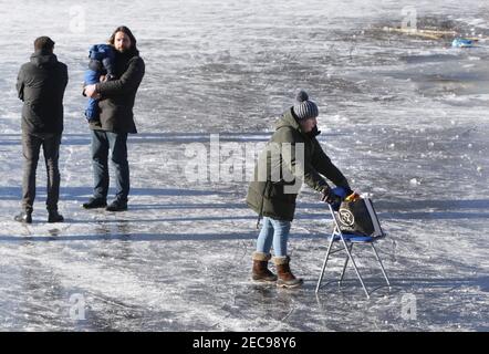 Amsterdam, Niederlande. Februar 2021, 13th. Am 13. Februar 2021 in Amsterdam, Niederlande, genießen die Menschen den gefrorenen Kanal im Rembrandt Park. Der niederländische Ministerpräsident Mark Rutter fragte die Menschen während der Pressekonferenz am vergangenen Freitag nicht brechen die Maßnahmen gegen Covid-19 auch auf dem Eis, das Virus ist nicht weniger infektiös auf Eis. (Paulo Amorim/Sipa USA) Quelle: SIPA USA/Alamy Live News Stockfoto