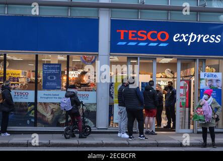 Eine Schlange von Menschen vor dem Tesco Express Supermarkt im Stadtzentrum von Dublin während der COVID-19 Pandemiesperre gesehen.Level 5 Sperrbeschränkungen werden von der irischen Regierung um mindestens weitere sechs Wochen verlängert werden, wobei nur Schulen und der Bausektor voraussichtlich vor Ostern wieder geöffnet werden dürfen. Stockfoto