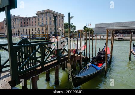 Leere Gondeln zwischen den Pylonen im Wasser des Canale Grande, Venedig, Italien. Stockfoto