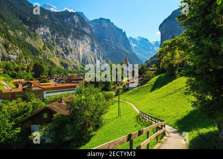 Schönes touristisches Bergdorf im spektakulären tiefen Tal. Fantastisches Reise- und Touristenziel, Lauterbrunnen Dorf mit Gletschern in BA Stockfoto