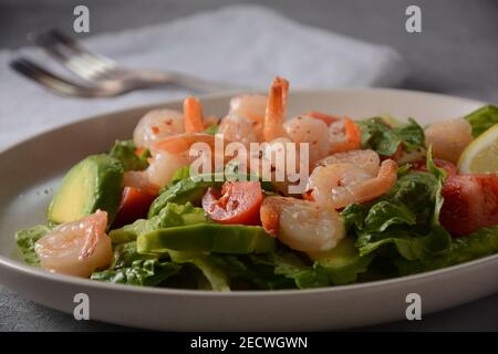 Avocado-Salat mit Garnelen und Kirschtomaten. Frühstück mit Meeresfrüchten Stockfoto