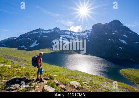 Wanderer auf dem Weg nach Innerdalstarnet, hinter See Storvatnet und Berg Skarfjell, Innerdalen, Trollheimen Berggebiet, Sunndal, Mehr OG Stockfoto