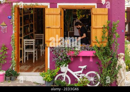 Kemalpaşa, izmir, türkei - 10,17.2020: Barista bereitet Kaffee in dem kleinen lila Café und weißen Fahrrad-Dekor zu. Stockfoto