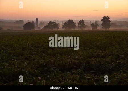 Scheune und Farmfelder in der Dämmerung in der Nähe von Churchtown, Lancaster County, Pennsylvania, USA Stockfoto