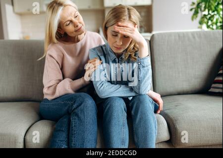 Besorgt ältere Mutter tröstet ihre Erwachsene Tochter, hilft mit Problem und Depression, Pflege sie, Empathie, Unterstützung in zwei Generationen. Unterstützung eines geliebten Menschen Stockfoto