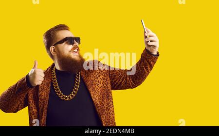 Lustige lächelnde rothaarige bärtige Mann macht Selfie auf dem Smartphone Stockfoto