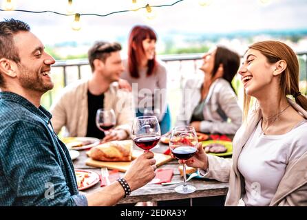 Glückliche Leute, die Spaß haben, Wein auf der Terrasse zu trinken Dinner Party - Junge Freunde essen Grillgerichte im Restaurant Gemeinsam Stockfoto