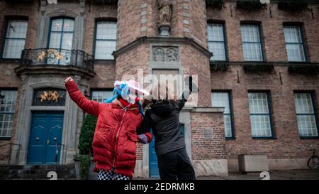 Düsseldorf, Deutschland. Februar 2021, 15th. Zwei Frauen feiern verkleidet vor dem Düsseldorfer Rathaus. Der Rheinische Straßenkarneval erreicht mit den Rosenmontagsparaden seinen Höhepunkt. Aufgrund von Corona wird jedoch die klassische Parade durch die Stadt in diesem Jahr abgesagt. Quelle: Fabian Strauch/dpa/Alamy Live News Stockfoto