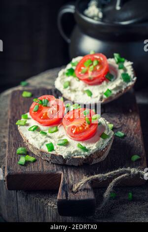 Hausgemachtes und leckeres Sandwich mit Schaumkäse und Kirschtomaten Stockfoto