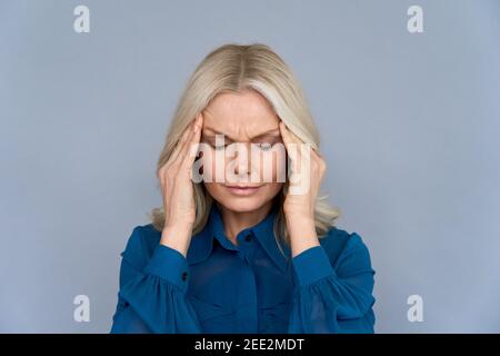 Gestresste Dame mittleren Alters, die an Kopfschmerzen oder Migräne leidet, Nahaufnahme. Stockfoto