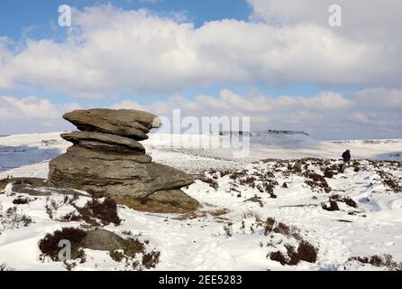 Walker auf einem verschneiten Weg von über Owler Tor zu Higger Tor im Peak District Stockfoto