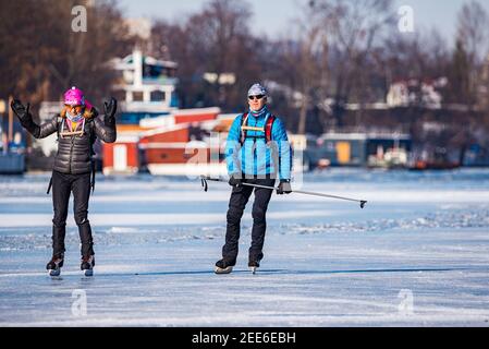 Prag, Tschechische republik - 14. Februar 2021. Sport aktiv paar Eislaufen auf gefrorenen Fluss Stockfoto