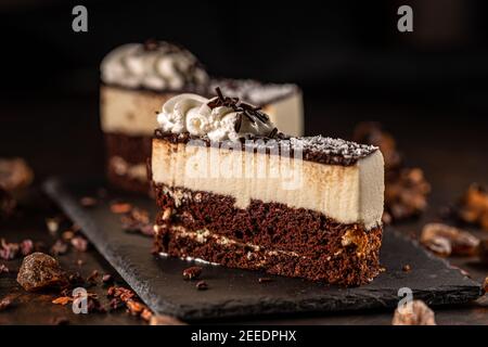 Ein Stück leckeren Mousse Kuchen aus Schichten von Schokolade Biskuitkuchen und Mousse Sahne Stockfoto