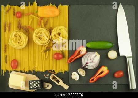 Hintergrund Layout für Kochen, Pasta und Gemüse, verteilt auf dem Tisch. Auf dem Tisch sind verschiedene Nudelsorten angeordnet. Leerzeichen für Text Stockfoto