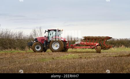 Case puma 200 landwirtschaftlichen Traktor Drehen einer sechs Furchen semi Am Ende eines Feldes wird der Pflug montiert Stockfoto