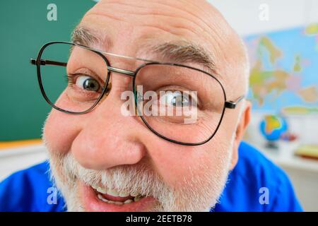 Lächelnder Lehrer mit lustigem Gesicht. Lehrertag. Lernen, Bildung und Schulkonzept. Stockfoto