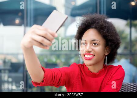 Afro-Frau nimmt Selfie mit Smartphone im Café Stockfoto