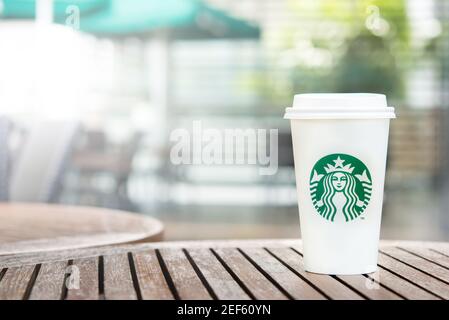 BANGKOK, THAILAND - JUN 29, 2016 : Starbucks Take Away Kaffeetasse auf Holztisch im Starbucks Coffee Shop Stockfoto