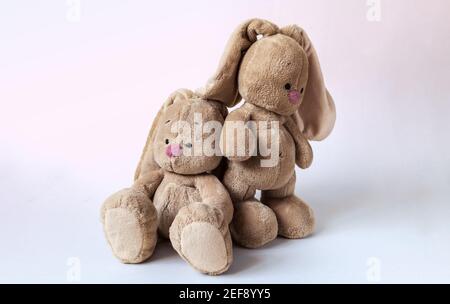 Ein niedliches Baby weiche Spielsachen Hasen wandte sich weg im Streit Auf einem hellen rosa Hintergrund Stockfoto