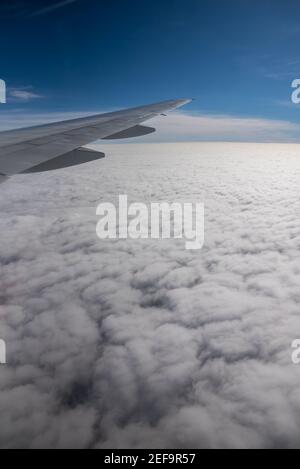 Luftaufnahme aus einem Flugzeug. Fliegen über den Wolken bei Sonnenaufgang Stockfoto