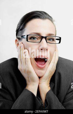 Porträt einer Geschäftsfrau mit den Händen am Kinn Stockfoto