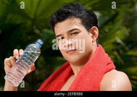 Porträt eines jungen Mannes mit einer Flasche Wasser Stockfoto