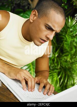 Nahaufnahme eines jungen Mannes, der einen Laptop benutzt Stockfoto