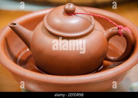 Traditionelle chinesische Teetasse in einer Schüssel mit brauner Farbe. Stockfoto
