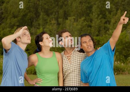 Junger Mann zeigt auf seine Freunde Stockfoto