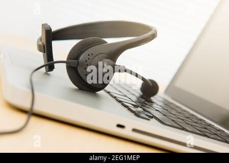 Mikrofon-Headset auf Laptop-Computer Stockfoto