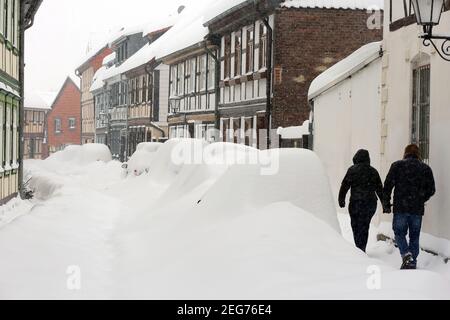 Wernigerode, Deutschland. Februar 2021, 08th. Eingeschneite Fahrzeuge stehen am Straßenrand. Der Winter hat Teile von Sachsen-Anhalt wie hier in Wernigerode fest im Griff. Innerhalb kurzer Zeit wuchs die Schneedecke auf 50 Zentimeter. Die Rodungsdienste können den Schnee kaum verdrängen. Quelle: Matthias Bein/dpa-Zentralbild/ZB/dpa/Alamy Live News Stockfoto