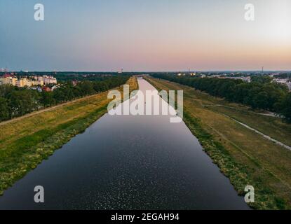 Luftaufnahme zum langen Fluss mit Wellen zwischen Bäumen an Sonniger Morgen Stockfoto