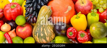 Eine Reihe von frischem Gemüse und Obst. Heller, schöner Hintergrund. Breites Foto . Stockfoto