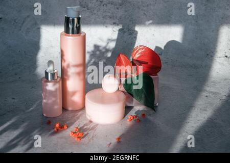 Kosmetische Schühchen mit Blumen o n grauem Hintergrund Stockfoto