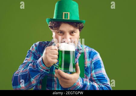 Portrait von glücklichen jungen Mann in Party Hut trinken grün Bier am St. Patrick's Day Stockfoto