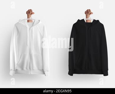 Mockup aus weißem, schwarzem Hoodie mit Reißverschluss, Taschen hängen an einem Kleiderbügel in der Hand, leere Langarm-Kleidung isoliert auf dem Hintergrund. Sweatshirt t Stockfoto