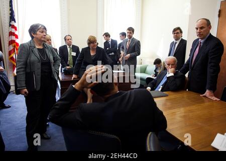 Präsident Barack Obama und Vizepräsident Joe Biden, beide sitzen, hören Phil Schiliro, Assistent des Präsidenten für legislative Angelegenheiten, rechts, Montag, 23. Februar 2009, Während eines Meetings in einem Konferenzraum im Eisenhower Executive Office Building vor dem Eintritt in die Abschlusssitzung des Fiscal Responsibility Summit. Offizielles weißes Haus Foto von Pete Souza Stockfoto